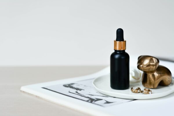 A bottle of serum sitting on top of a white plate.